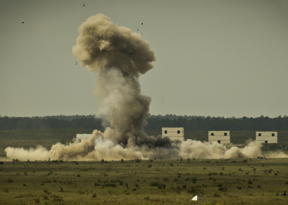 A cloud of heat and smoke erupts from the wreckage after a 1,500 pound explosive detonated in a controlled explosion on the Eglin Air Force Base range