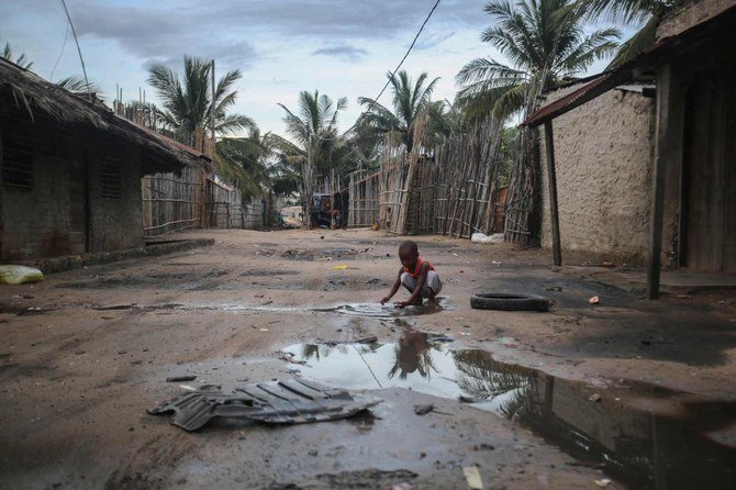 A child plays in an alley at the Port of Paquitequete near Pemba, March 29, 2021, where sailing boats are expected to arrive with people displaced from the coasts of Palma and Afung