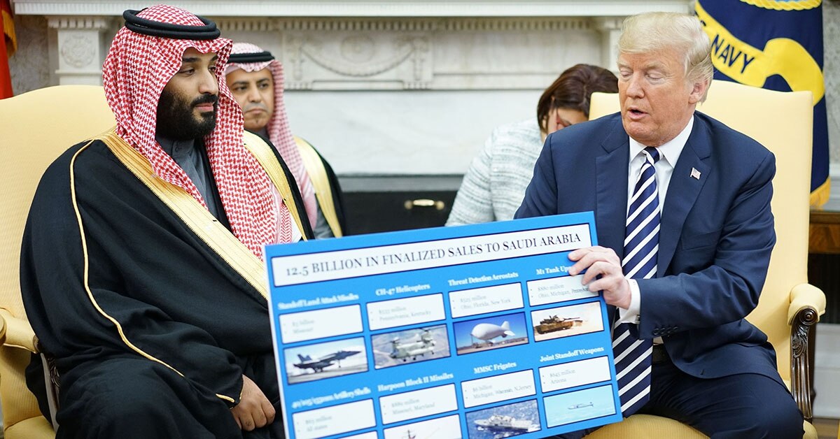 US President Donald Trump holds a defense sales chart with Saudi Arabia's Crown Prince Mohammed bin Salman in the Oval Office of the White House on March 20, 2018 in Washington, DC
