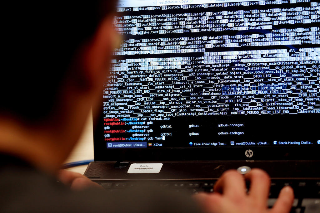Someone behind a laptop hacking