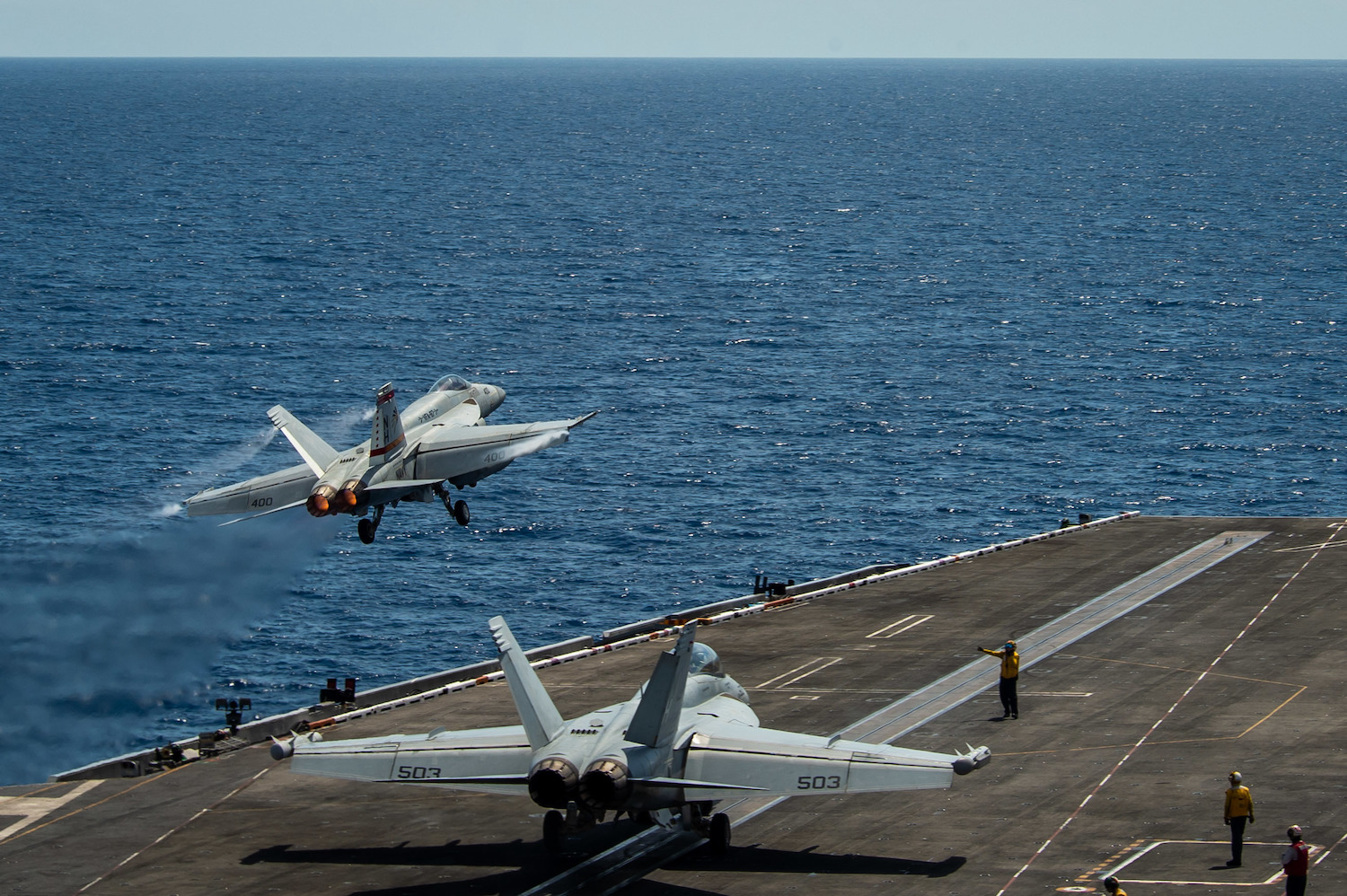 An F/A-18E Super Hornet, assigned to the “Golden Warriors” of Strike Fighter Squadron (VFA) 87, launches from the flight deck of the aircraft carrier USS Theodore Roosevelt (CVN 71) April 6, 2021.
