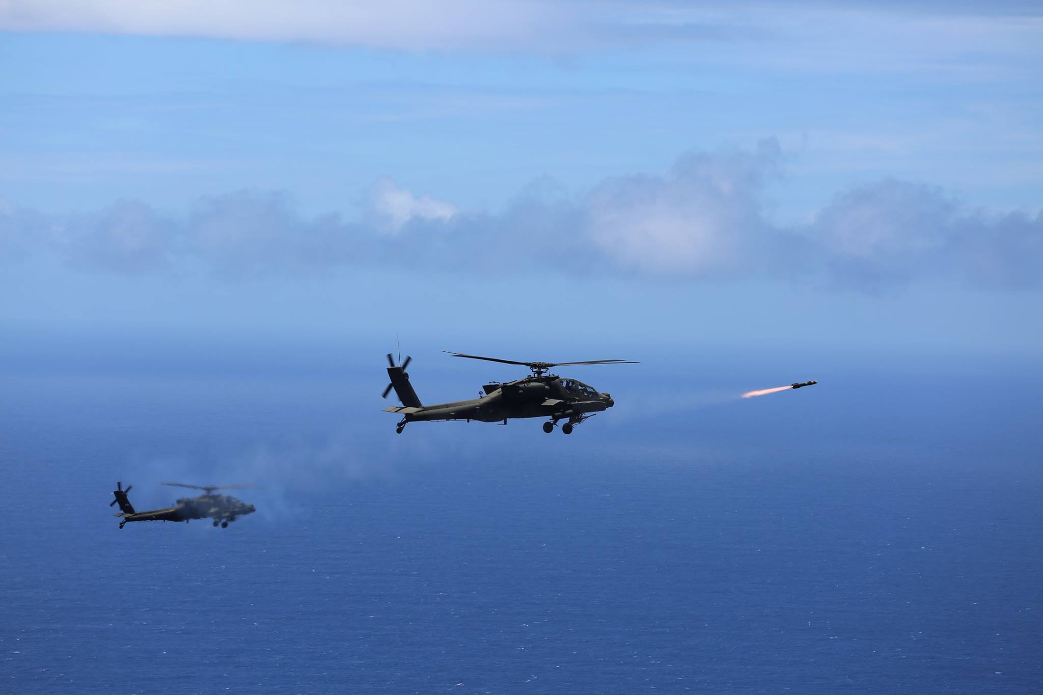 Two US Army AH-64D Apache attack helicopters launch eight 