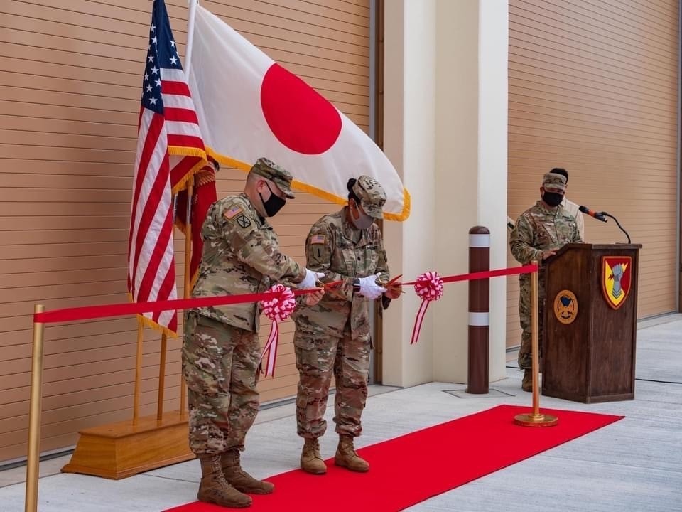 two men cutting ribbons