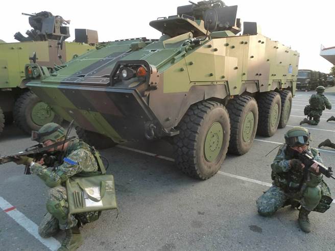 Taiwanese soldiers seen kneeling down beside armored vehicles dubbed the Clouded Leopards. Photo: Army Command Headquarters