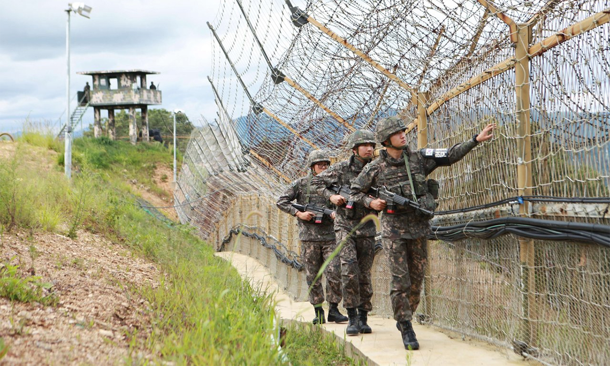 South Korean soldiers patrol along the line through the Demilitarized Zone in Hwacheon County