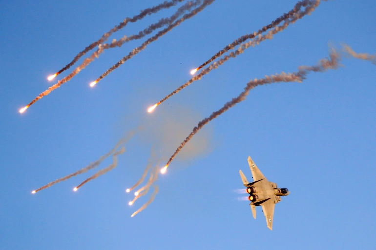 An Israeli F-15 I fighter jet launches anti-missile flares during an air show near the southern Israeli city of Beer Sheva