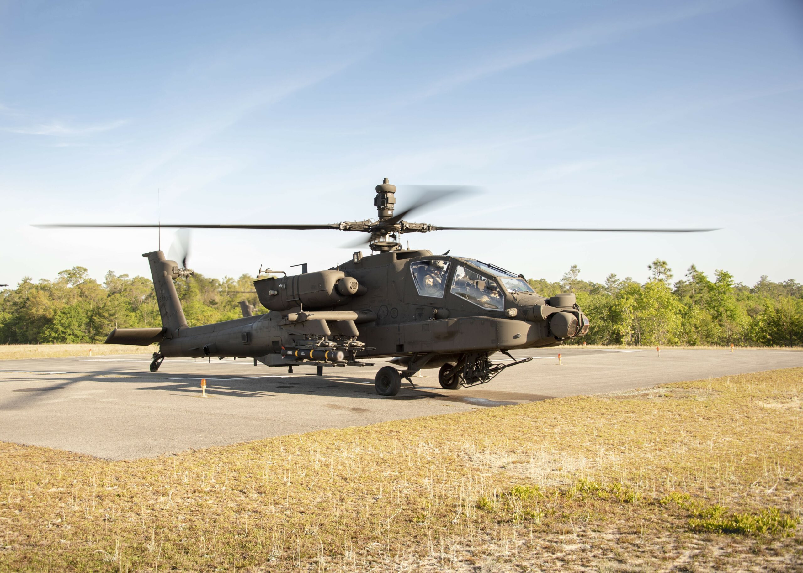 A Joint Air to Ground Missile (JAGM) is loaded onto an AH64E Apache Attack Helicopter