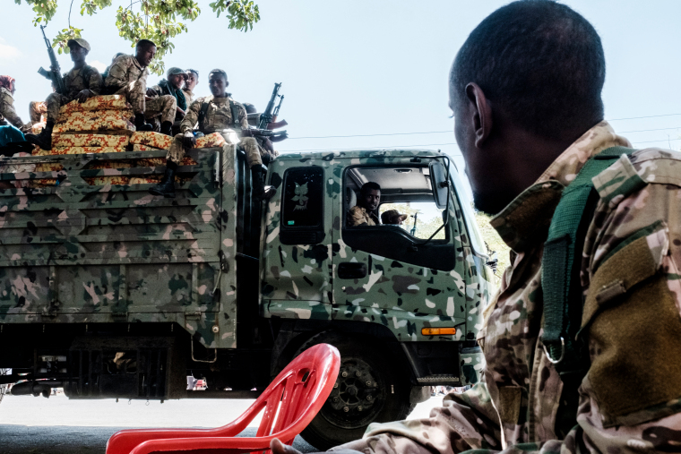 Members of the Amhara Special Forces seat on the top of a truck while another member looks on in the city of Alamata, Ethiopia, on December 11, 2020