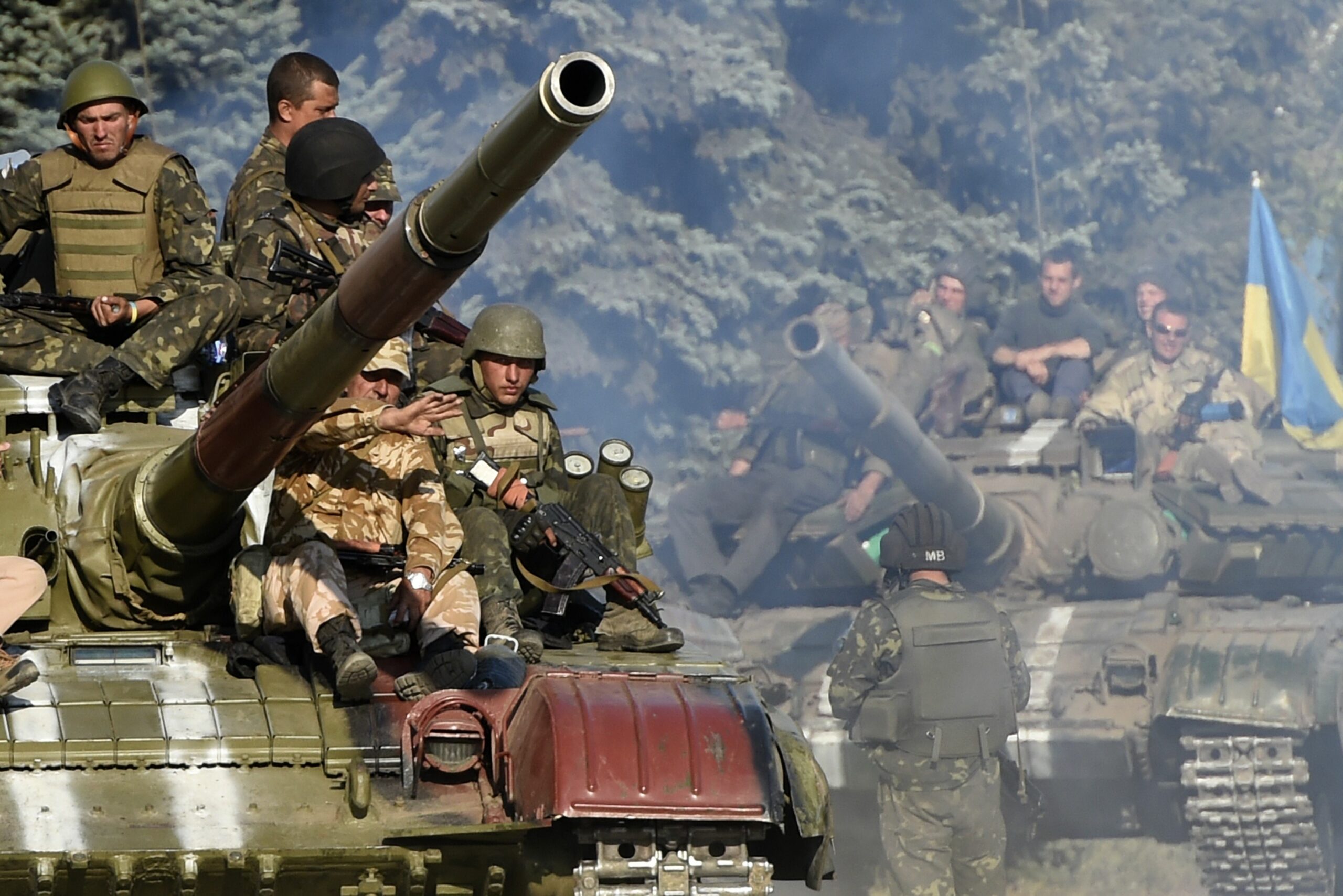 Ukrainian army soldiers ride a tank