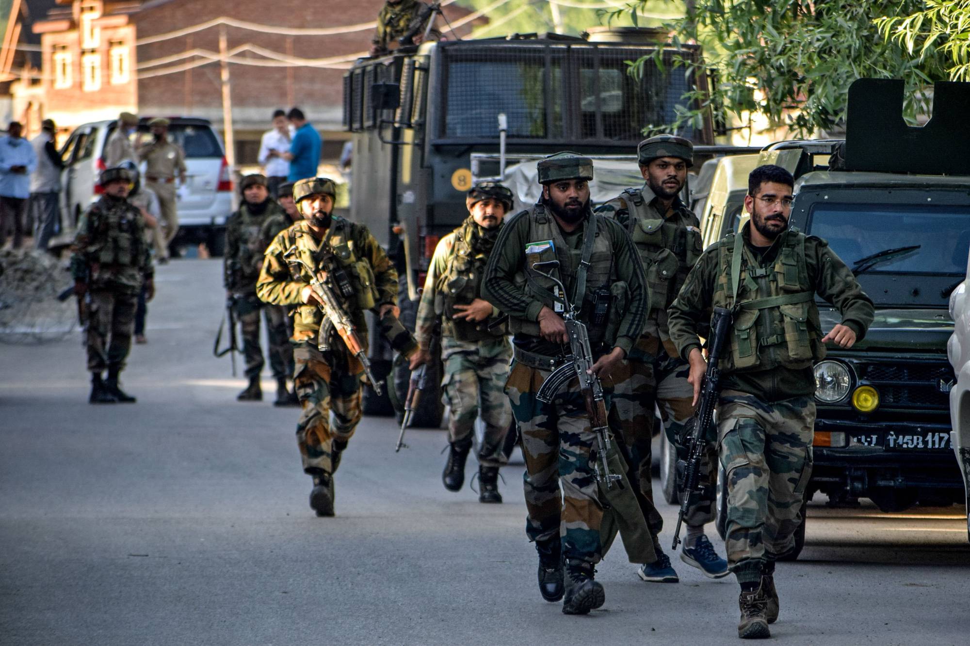 Security personnel arrive near the scene of a militant attack at Pandach Chowk