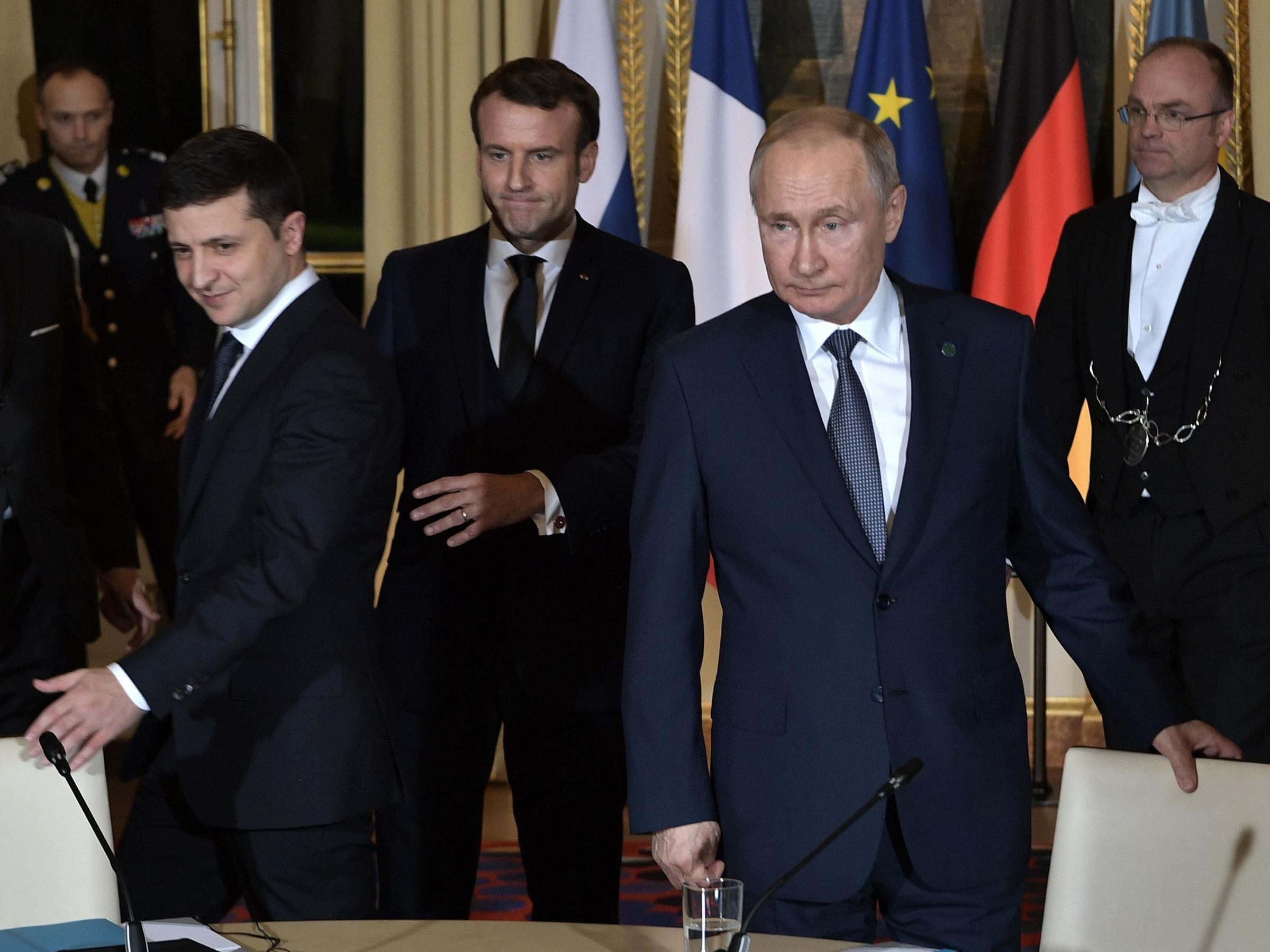 Ukrainian President Volodymyr Zelenskiy, French President Emmanuel Macron and Russian President Vladimir Putin arrive for a meeting on Ukraine with German Chancellor at the Elysee Palace