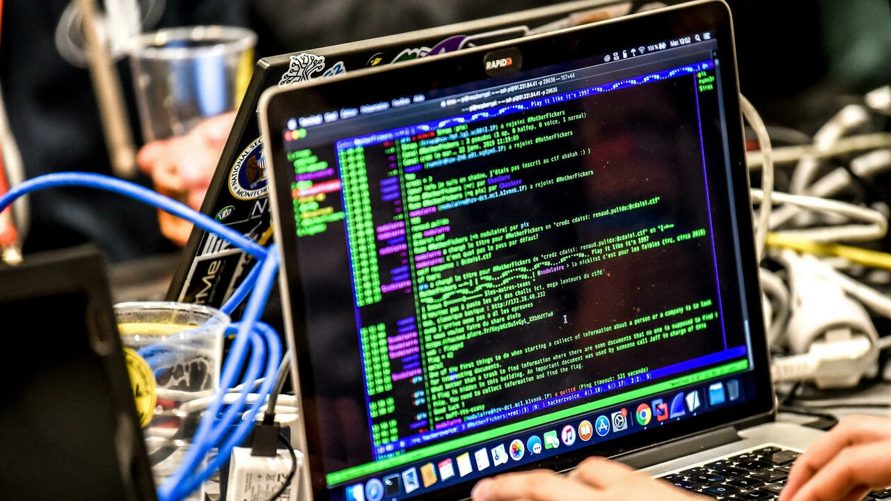 Closeup of hands working on a laptop