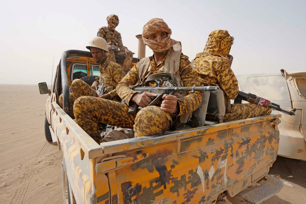 Fighters loyal to Yemen's Saudi-backed government hold a position against Houthi rebels