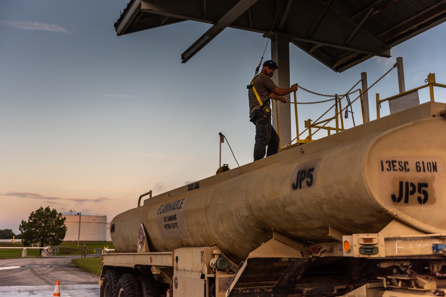 US army employee gauging fuel tanker