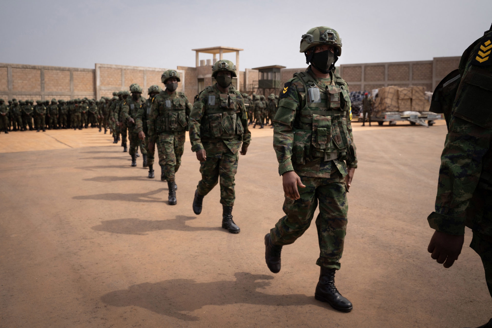 Rwandan soldiers and police officers board a plane at Kanombe airport in Kigali for a military mission to Mozambique