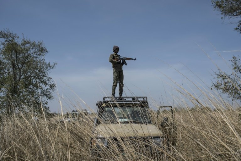 A guard on top of a vehicle in Benin