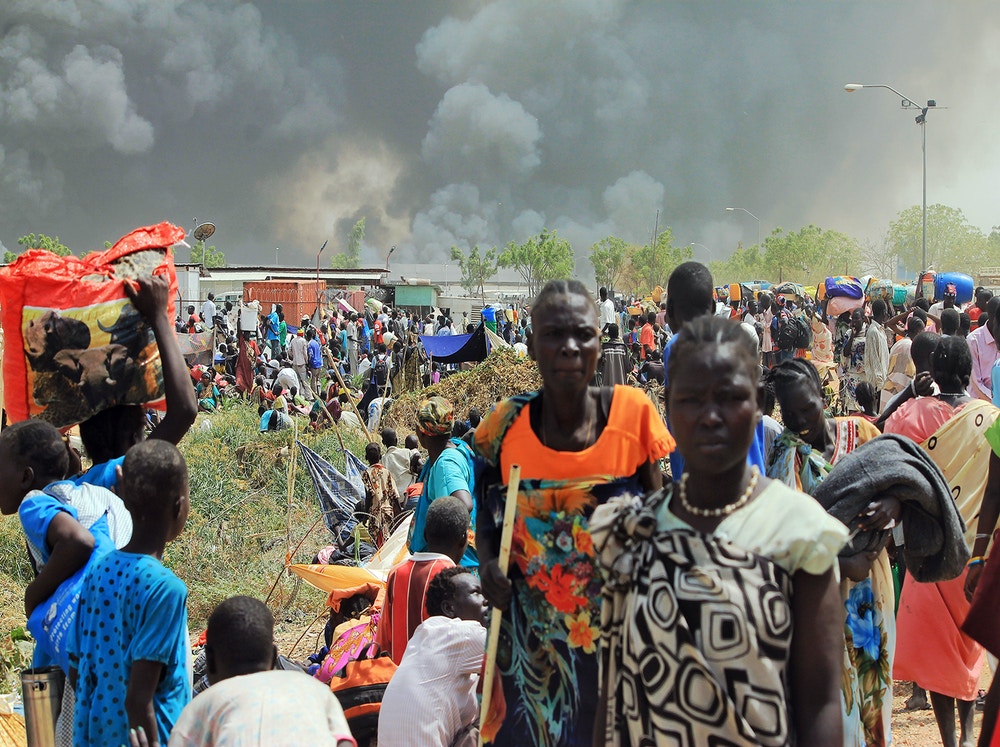 South Sudanese civilians flee fighting in the northeastern town of Malakal, where gunmen opened fire on people sheltering inside a United Nations base