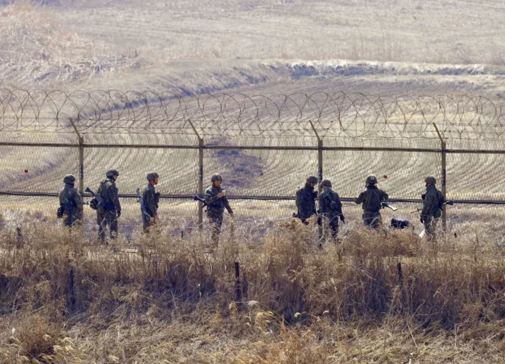 South Korean soldiers check a fence near the demilitarized zone between North and South Korea