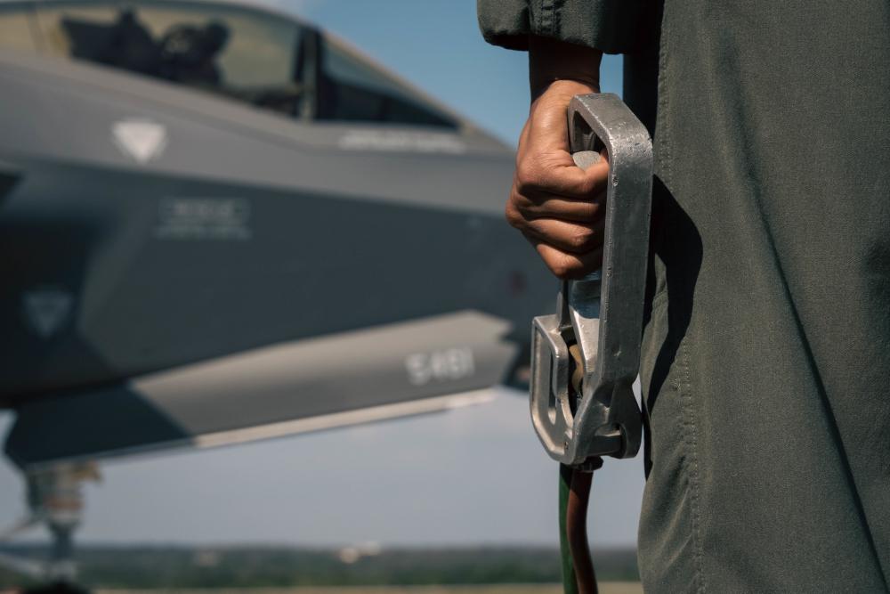 US Marine holding a dead man’s switch during hot-pit refueling training