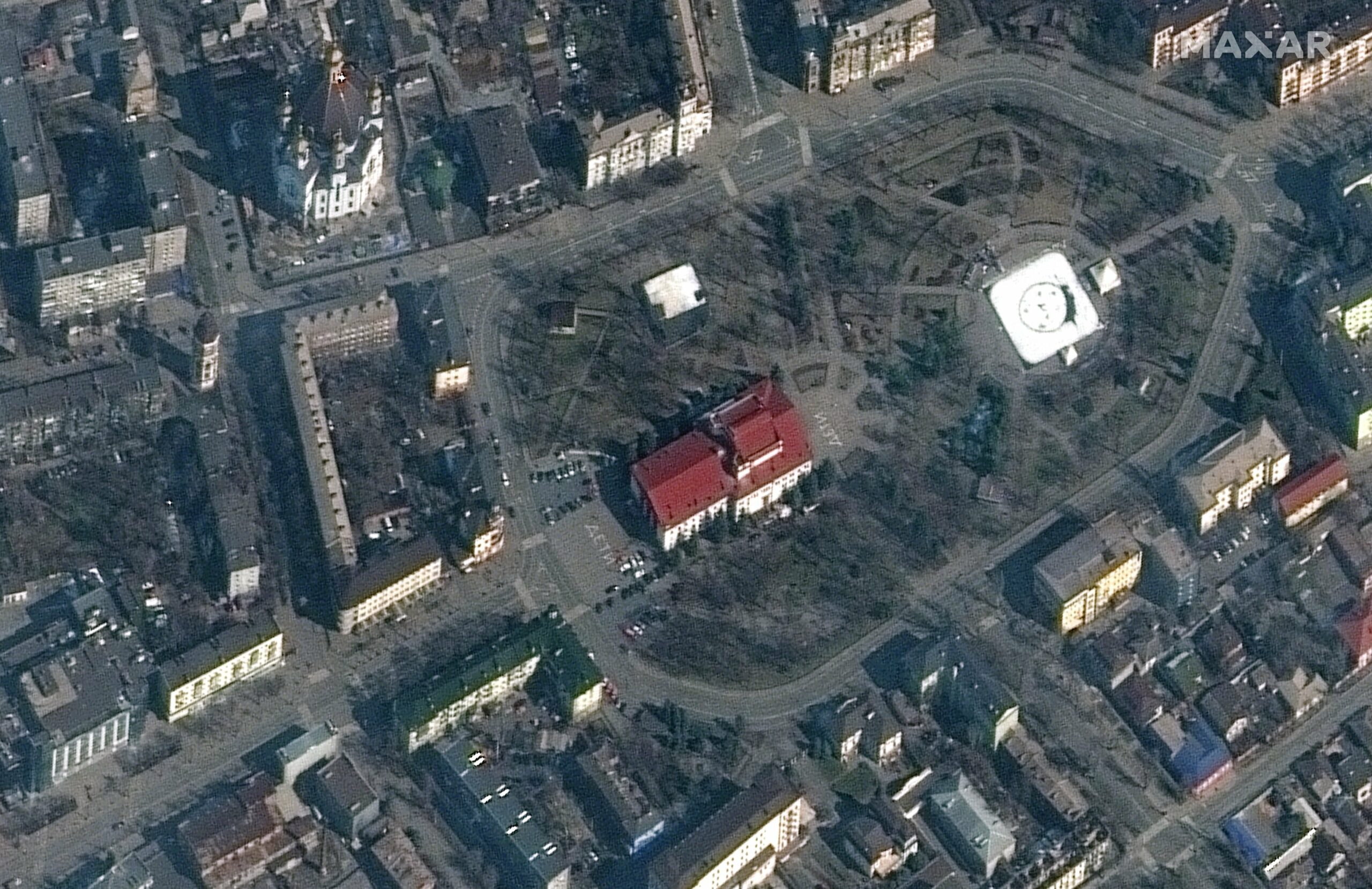 US private company Maxar satellite image taken on March 14, 2022 shows the word ‘children’ was painted in large Russian script on the ground outside the Mariupol Drama Theater