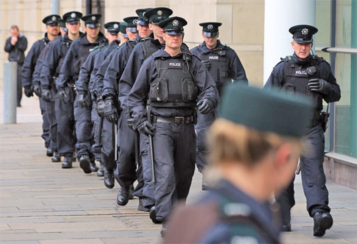 Police gather for the trial of loyalist gang members in Belfast