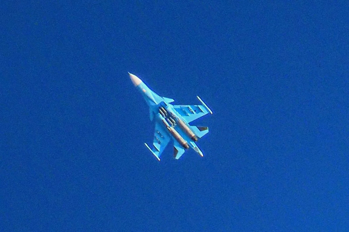 A Russian Air Force Sukhoi Su-34 flies over the city of Binnish in the eastern part of the Idlib province in northwestern Syria