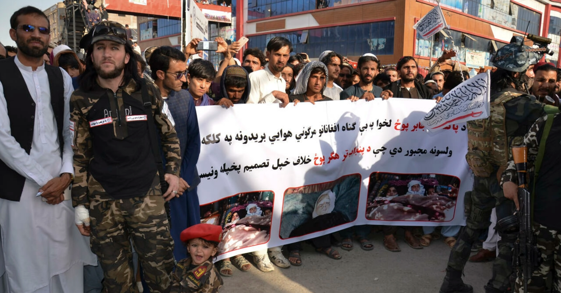 Demonstrators hold a banner during a protest against Pakistani airstrikes in Khost