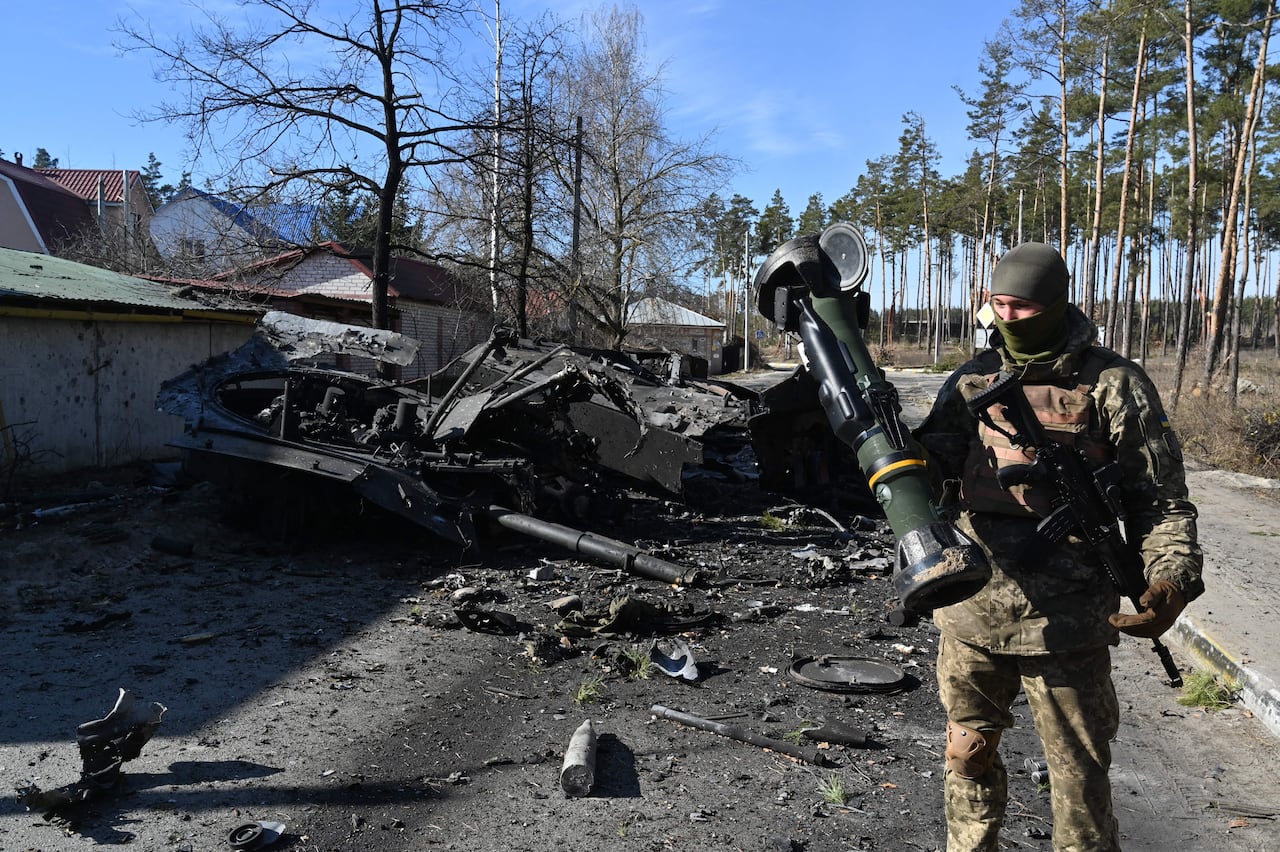 A Ukrainian soldier is seen holding an anti-tank weapon