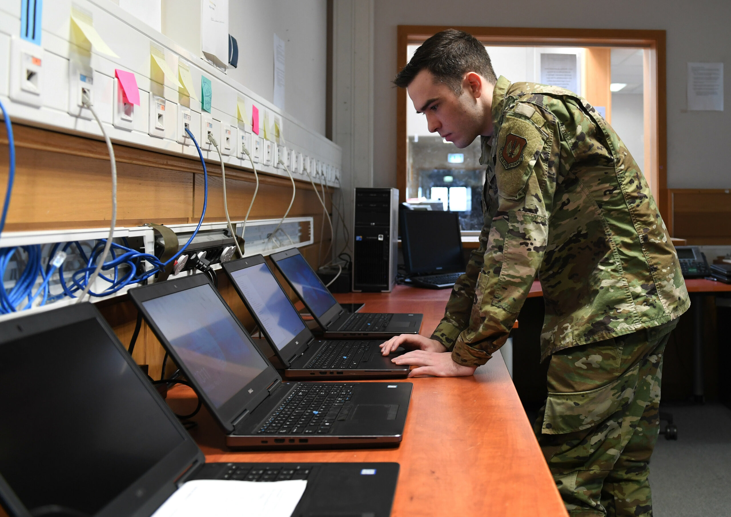 U.S. Air Force Airman client systems technician, works on a computer in a back shop at Spangdahlem Air Base, Germany.