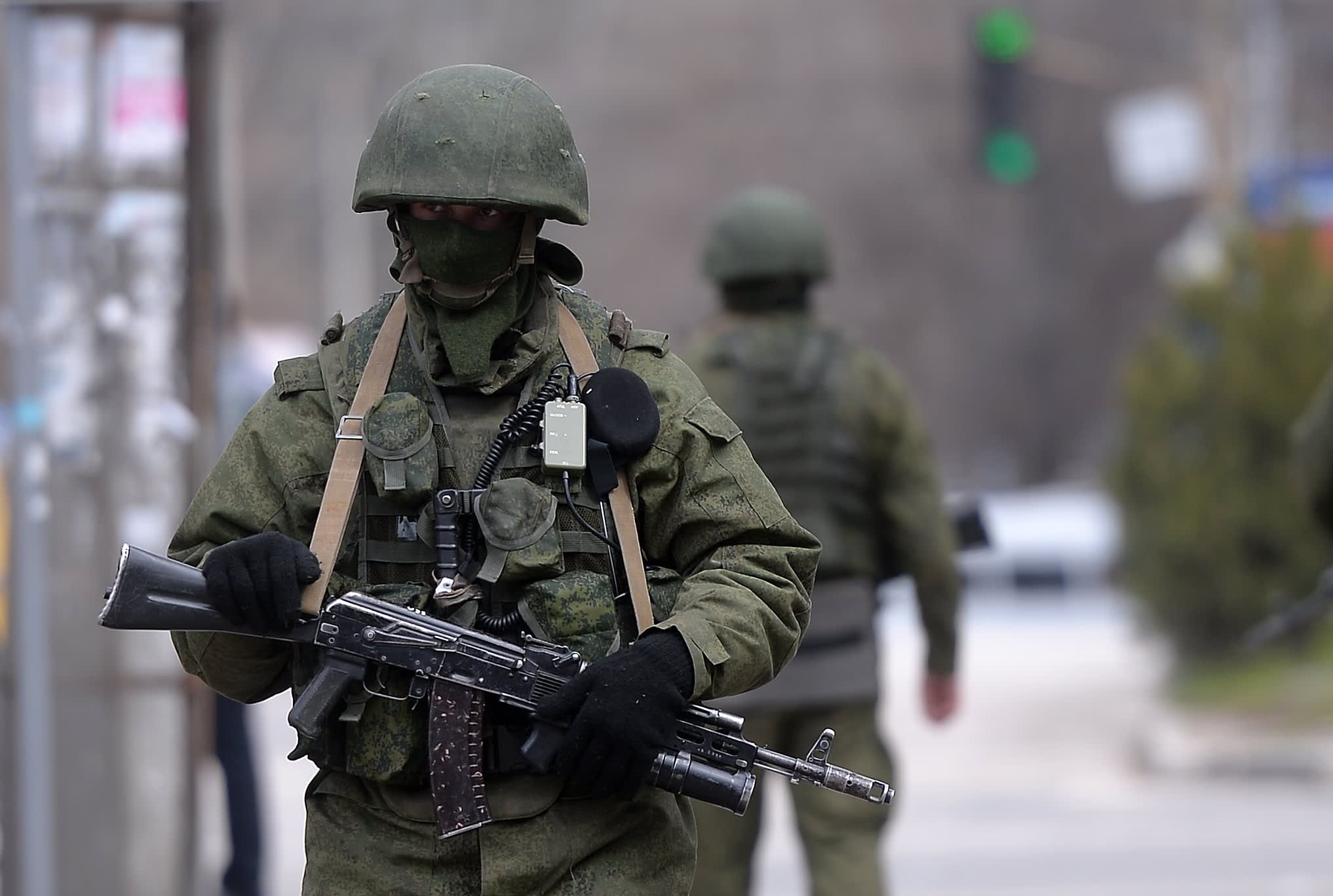 Russian soldiers patrol outside the navy headquarters in Simferopol, Crimea