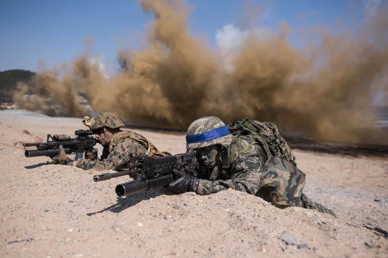 South Korean and US soldiers take a position during an annual joint military landing exercise in Pohang, on South Korea's southeast coast, on March 12, 2016