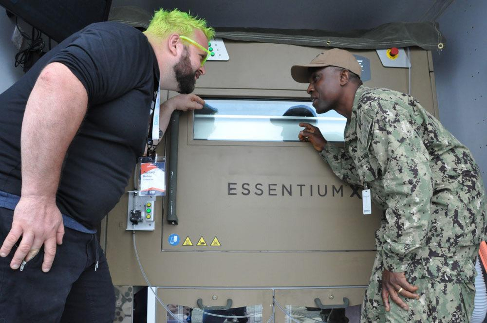 Zack Burhop with Essentium Inc. and Boatswains Mate 2nd Class Emmanuel Kuti at REPTX.