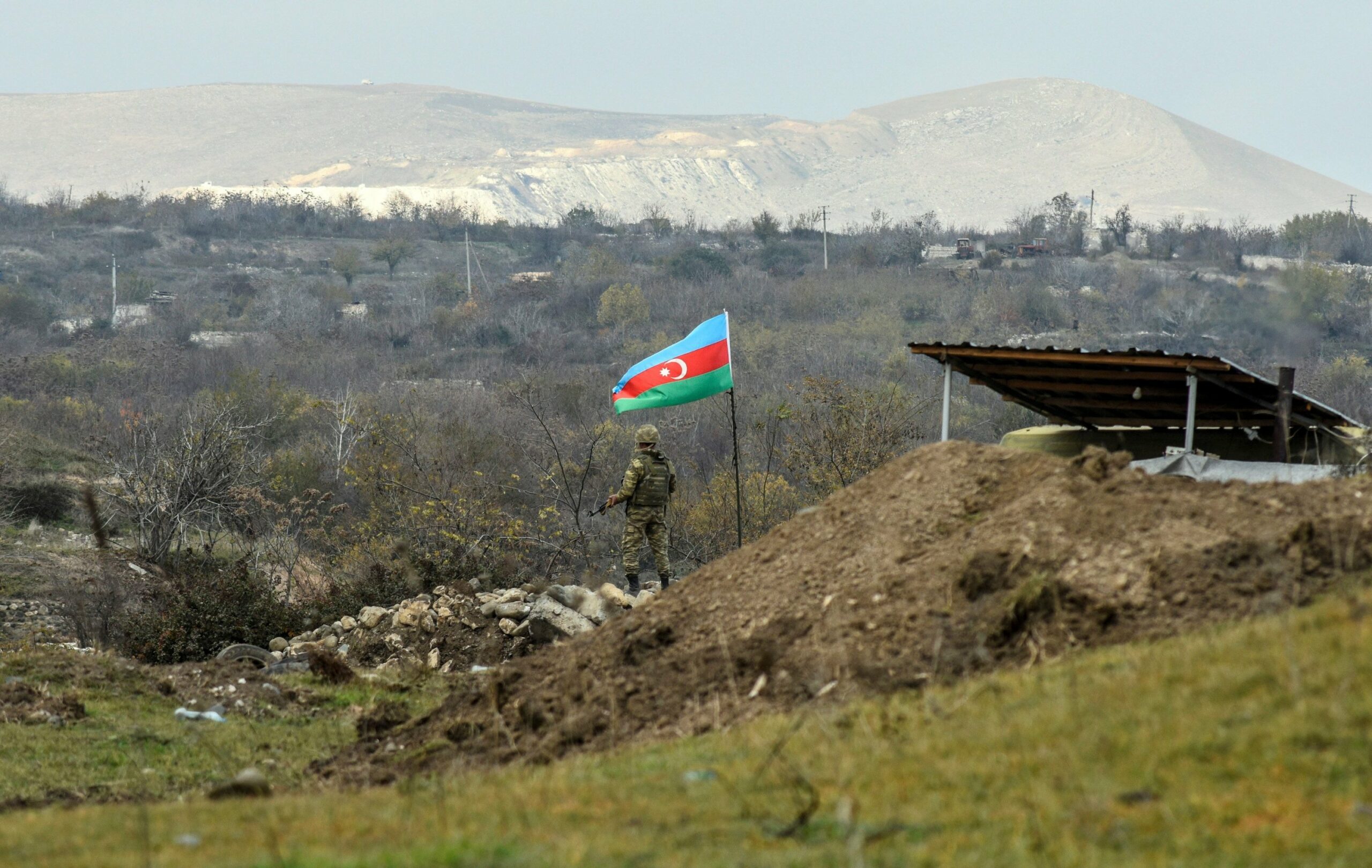 Azerbaijani soldier stands guard at a checkpoint on a road entering Fuzuli from Hadrut in Nagorno Karabakh