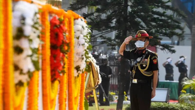A file photo shows then-Commanding-in-Chief Eastern Command of Indian Army Lieutenant General Anil Chauhan salutes during a ceremony to mark “Vijay Diwas