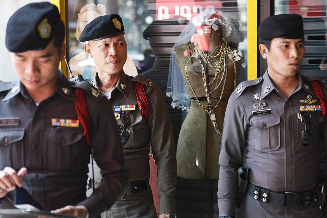 Thai policemen stand guard outside a building in Bangkok