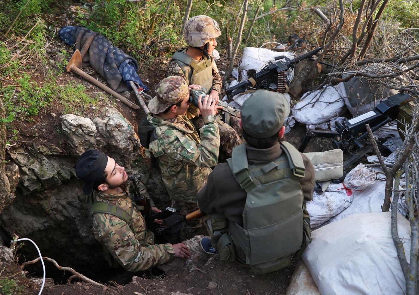 Fighters affiliated to the Hayat Tahrir al-Sham (HTS) militant group in the countryside of Syria's northwestern Latakia province