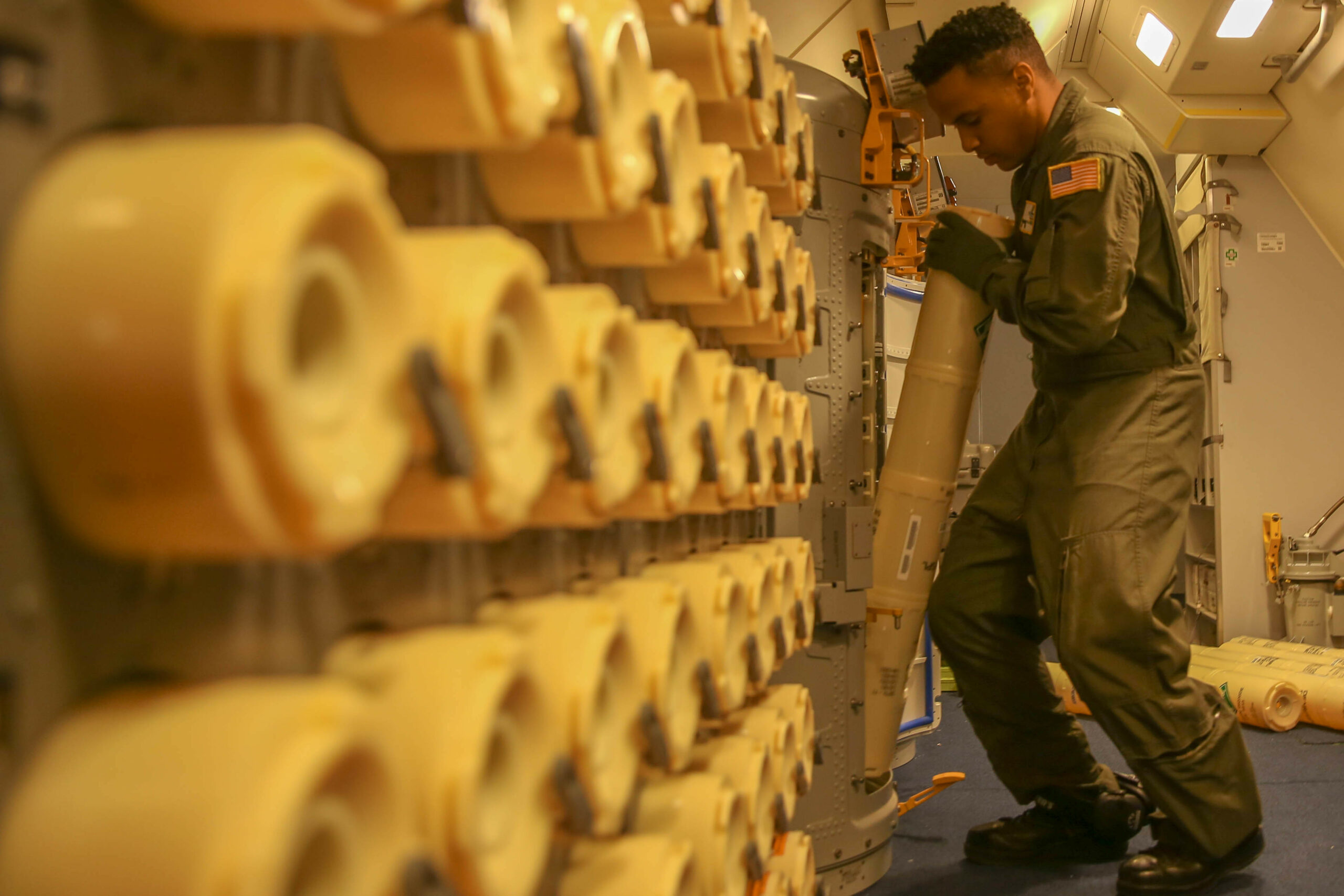 Naval Air crewman loads sonobuoys aboard a P-8A Poseidon aircraft. Photo: Lance Cpl. Joseph Atiyeh/USMC