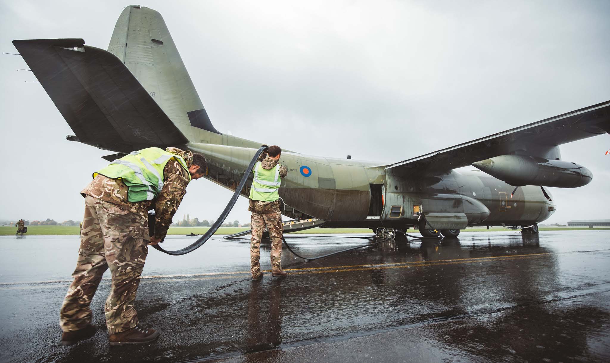 RAF personnel handling C-30J refueling hose.