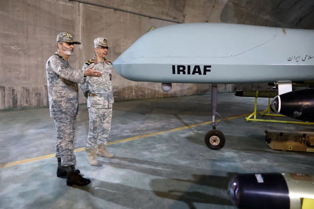 Commander-in-Chief of the Iranian Army Major General Abdolrahim Mousavi (left) and Armed Forces Chief of Staff Major General Mohammad Bagheri visit an underground drone base, in an unknown location in Iran