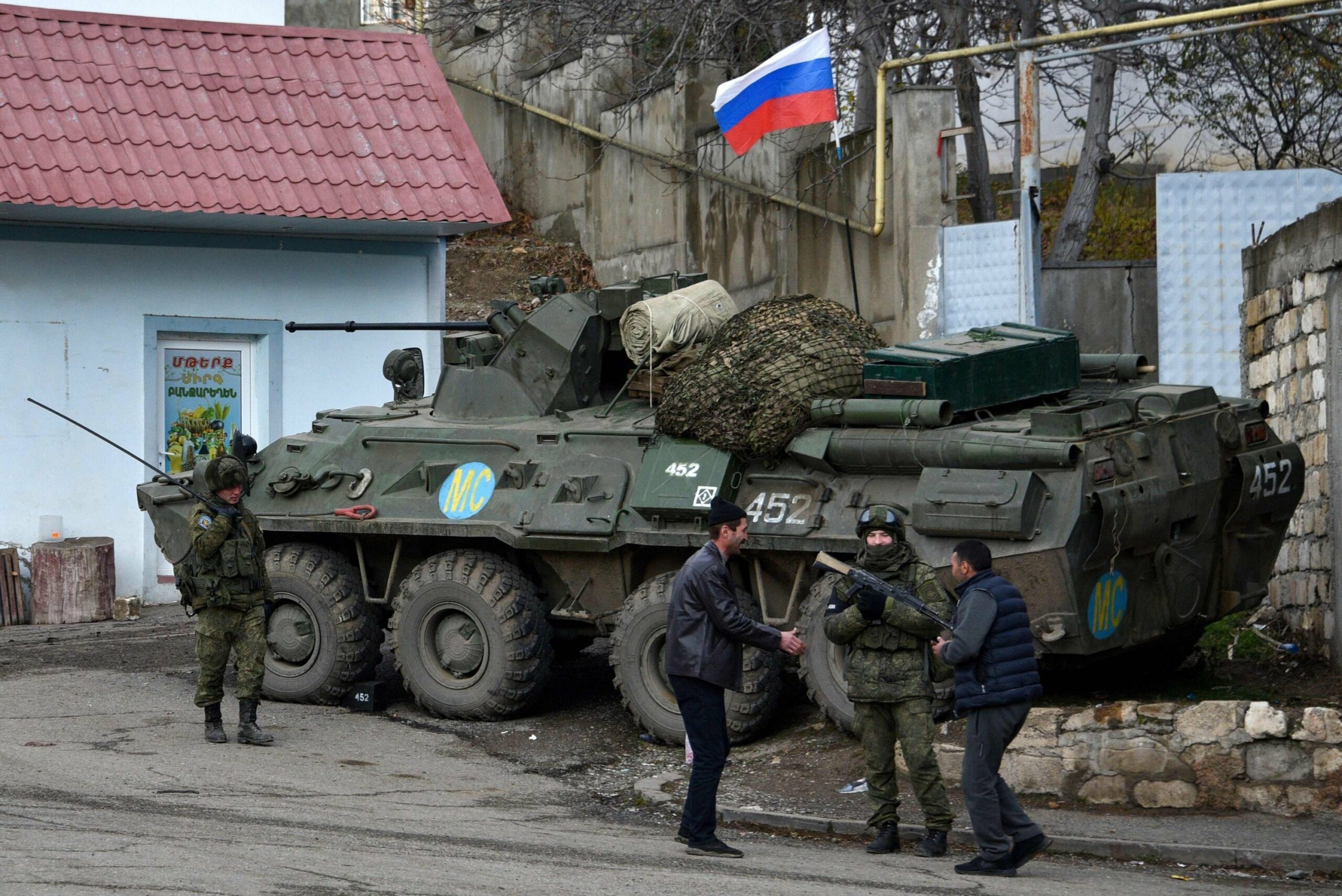 Men interact with Russian peacekeepers in the town of Lachin, Nagorno-Karabakh region, Azerbaijan