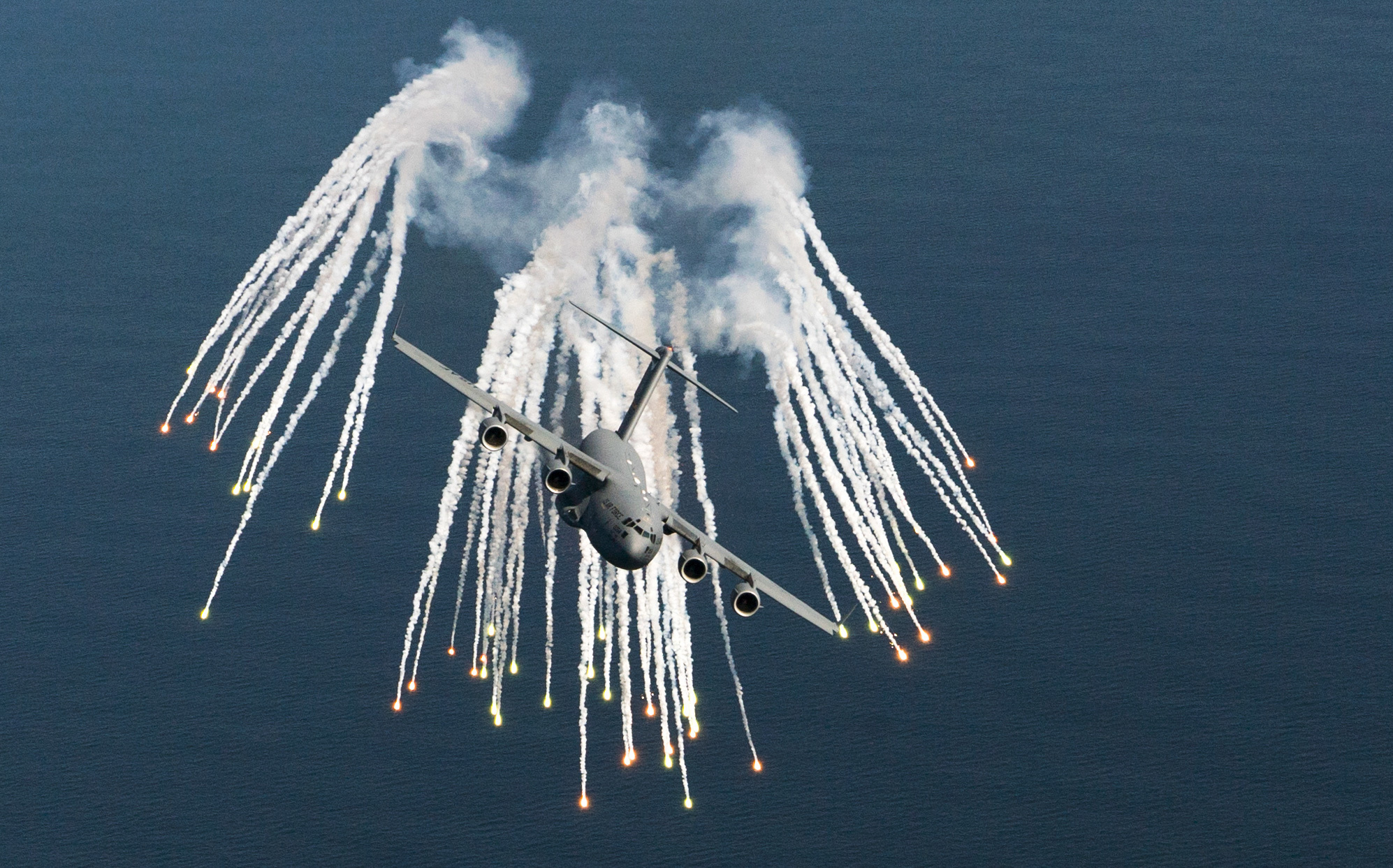 A C-17 Globemaster III aircraft dispenses flares
