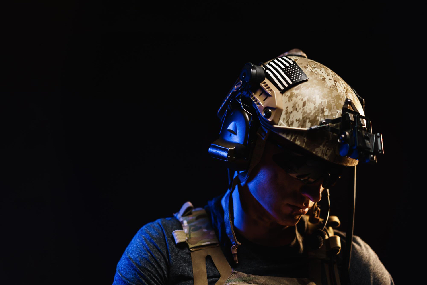 Portrait of special forces soldier in helmet and glasses in the dark