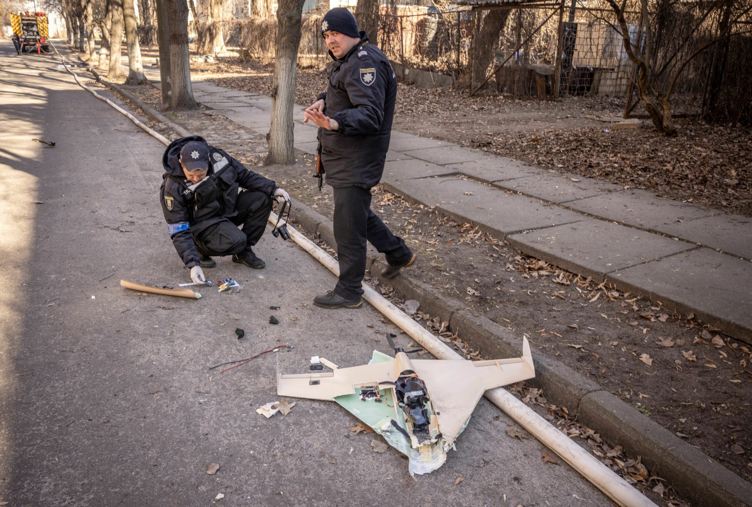 Ukrainian police officers inspect a downed Russian drone after a strike in northwestern Kyiv