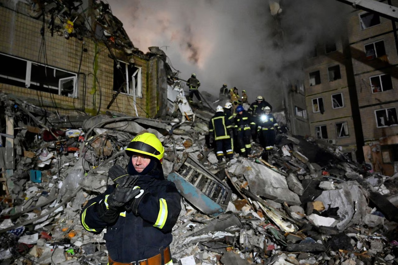 Rescuers work at the site of a Russian missile strike on an apartment building in the Ukrainian city of Dnipro