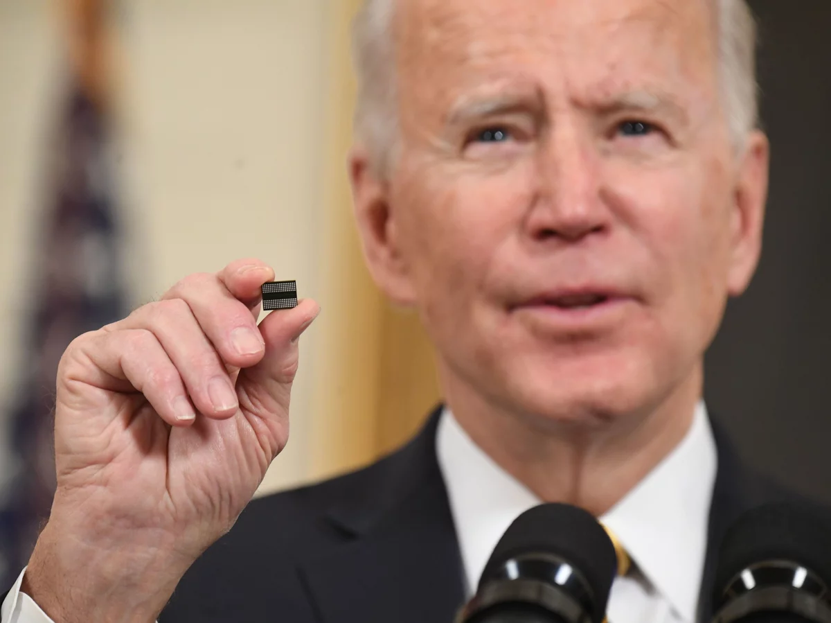 President Biden holds a semiconductor chip