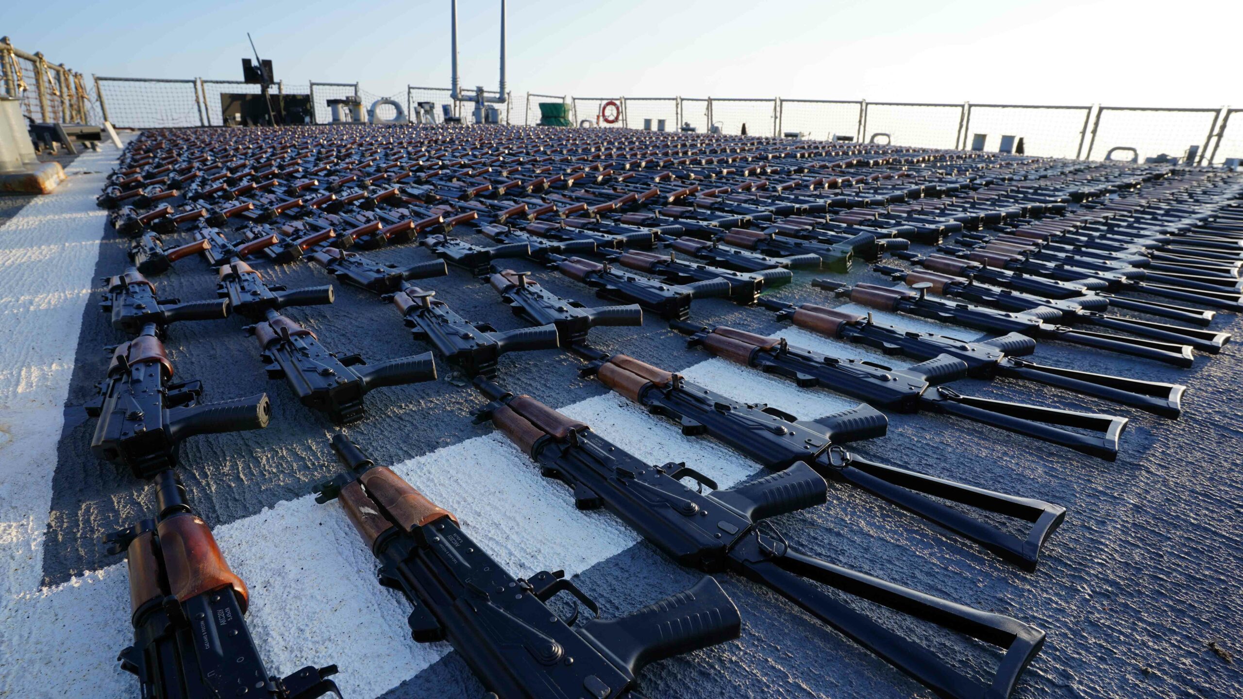 Thousands of AK-47 assault rifles sit on the flight deck of guided-missile destroyer USS The Sullivans