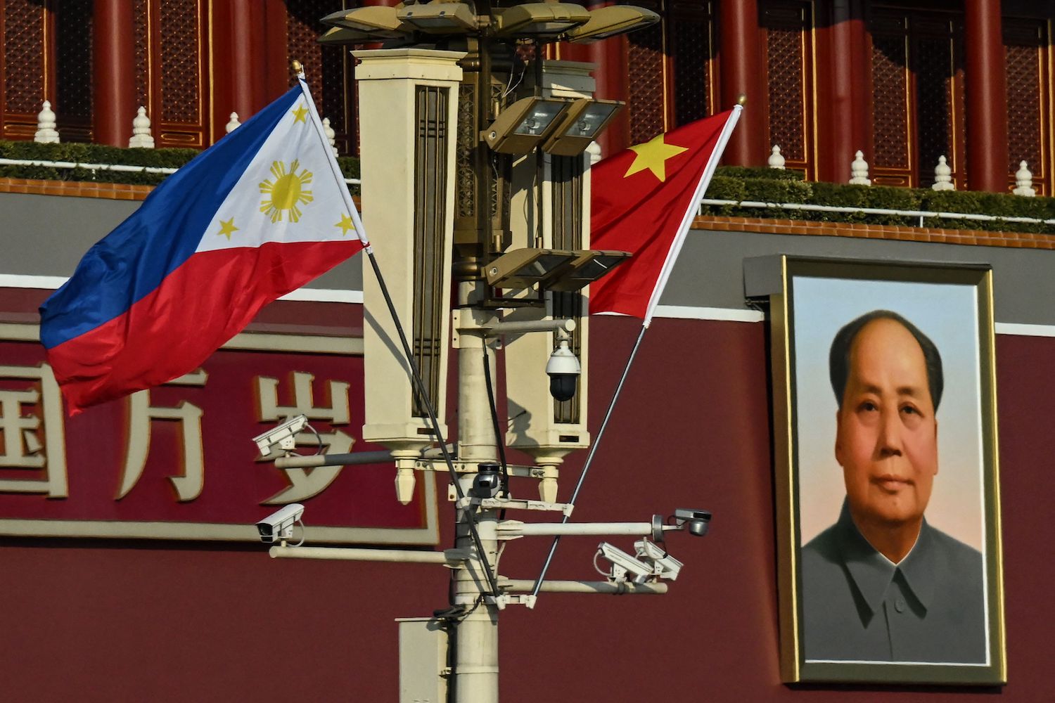 The national flags of the Philippines and China are seen together near the Tiananmen Gate
