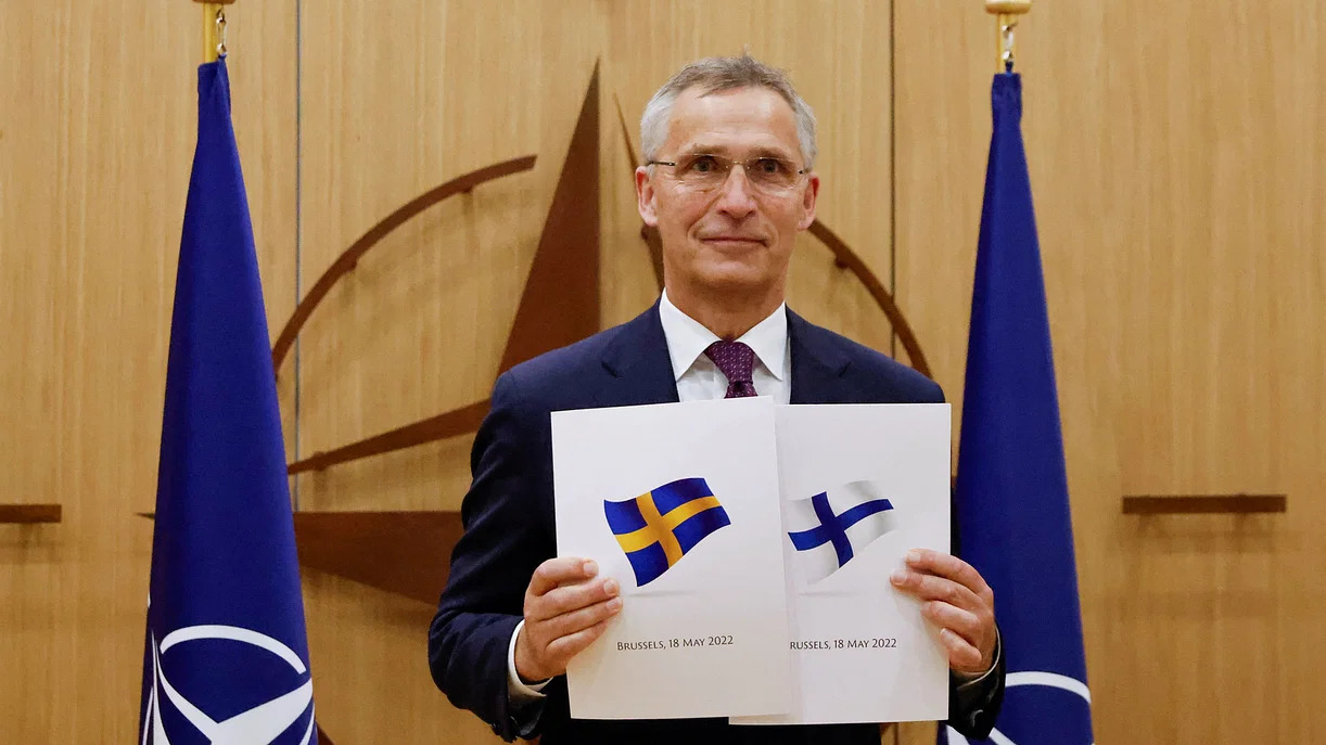 NATO Secretary-General Jens Stoltenberg holds application documents presented by Finland and Sweden