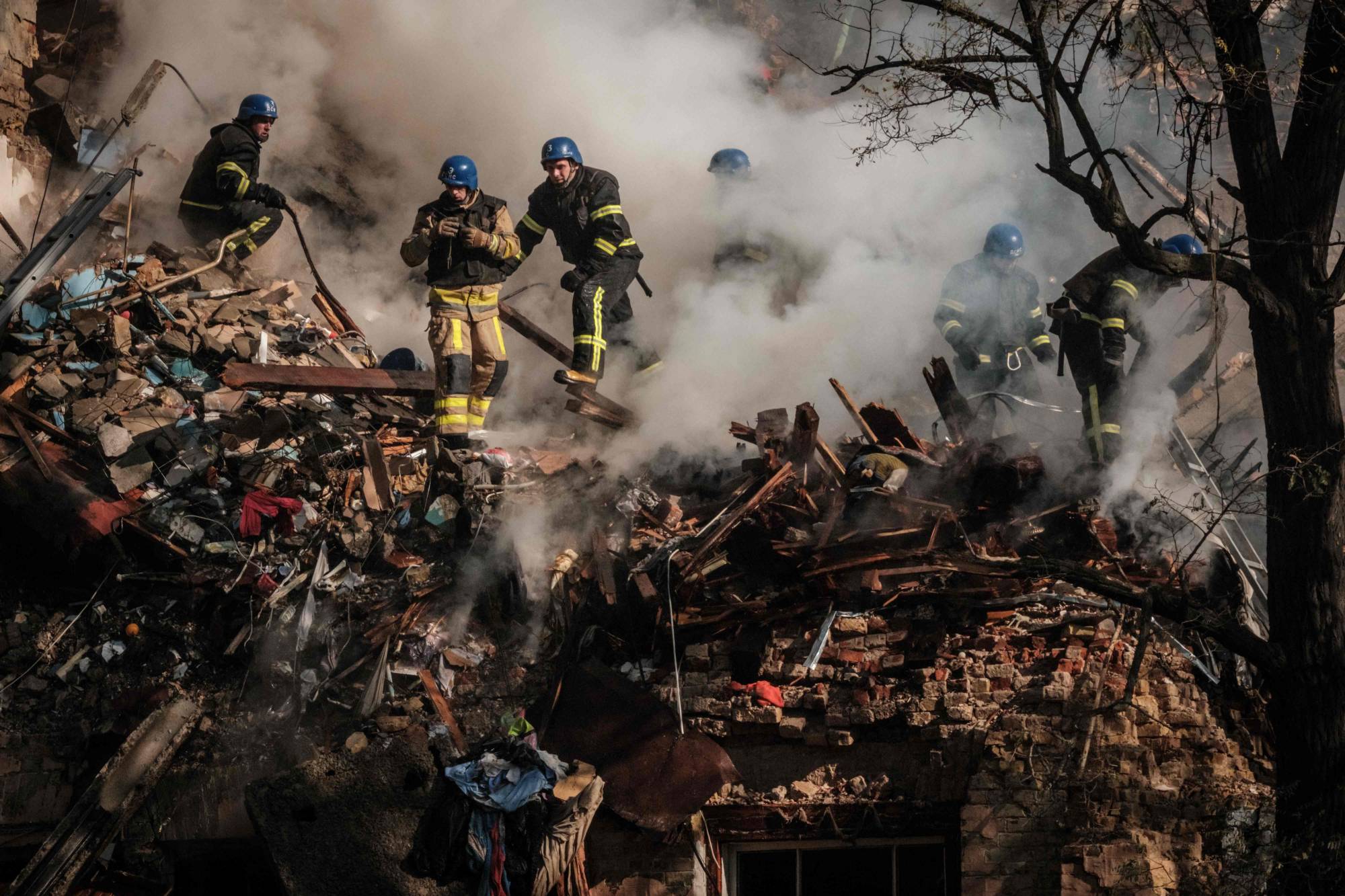 Ukrainian firefighters works on a destroyed building after a drone attack in Kyiv