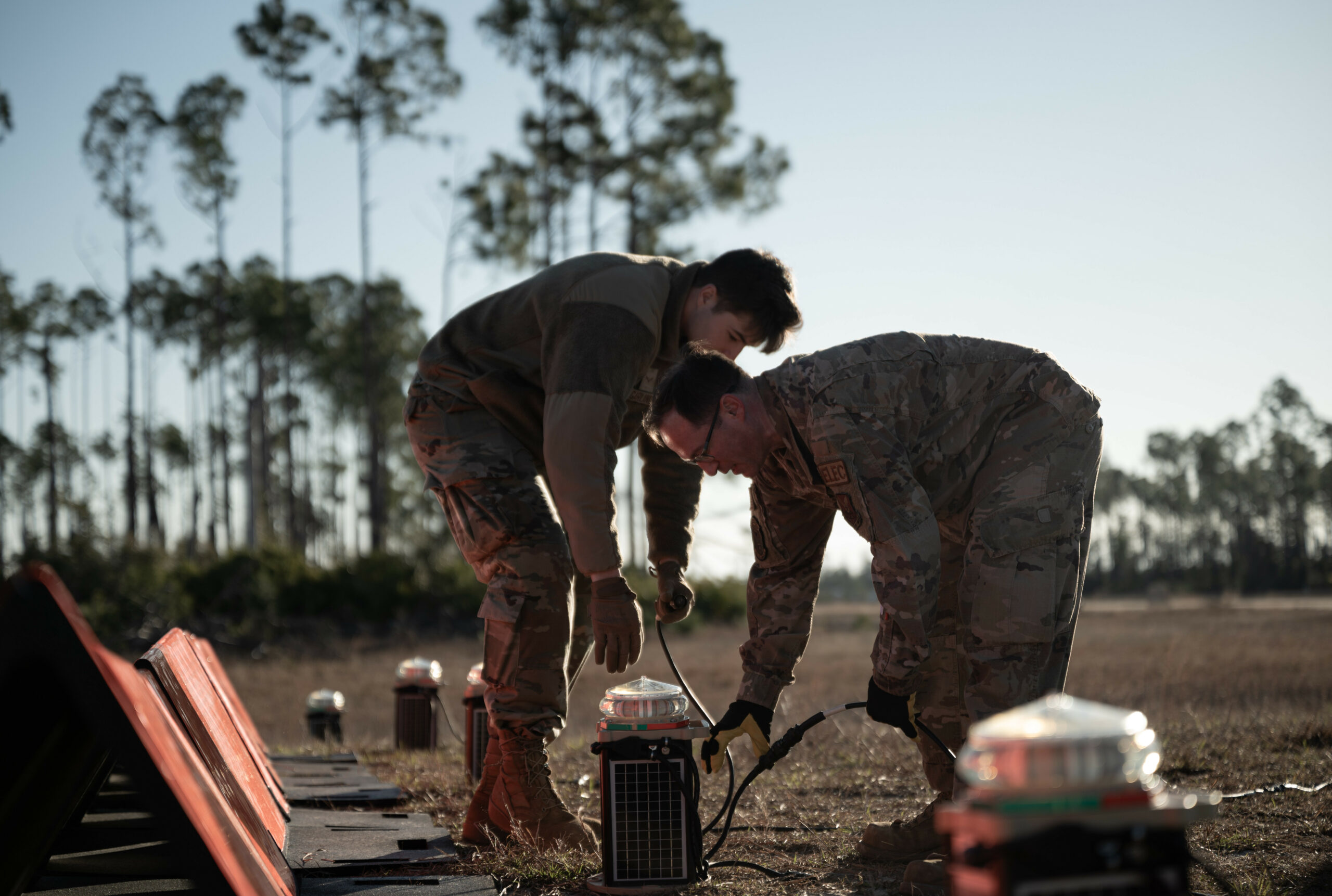 U.S. Airmen assemble an Expeditionary Airfield Lighting System (EALS-C) during the first-ever Mission Essential Equipment Training course held at Tyndall Air Force Base, Florida, Jan. 27, 2023. The MEET course familiarized Airmen with the EALS-C, a revolutionary lighting system that outshines its predecessor in timeliness, safety and efficiency. (U.S. Air Force photo by Senior Airman Anabel Del Valle)
